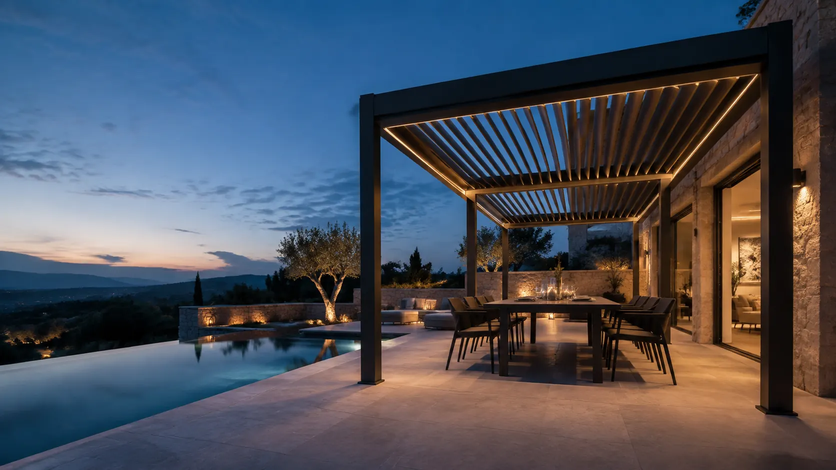 Graphite aluminum louvered pergola beside a Mediterranean villa at dusk